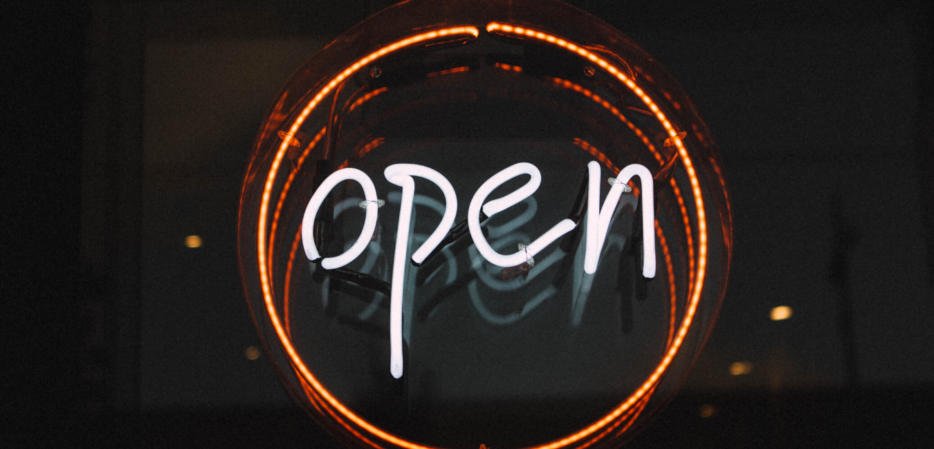 Illuminated open sign in orange ring