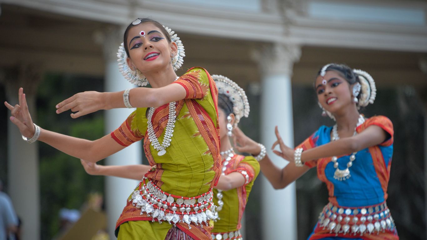 People in traditional indian clothes dancing together