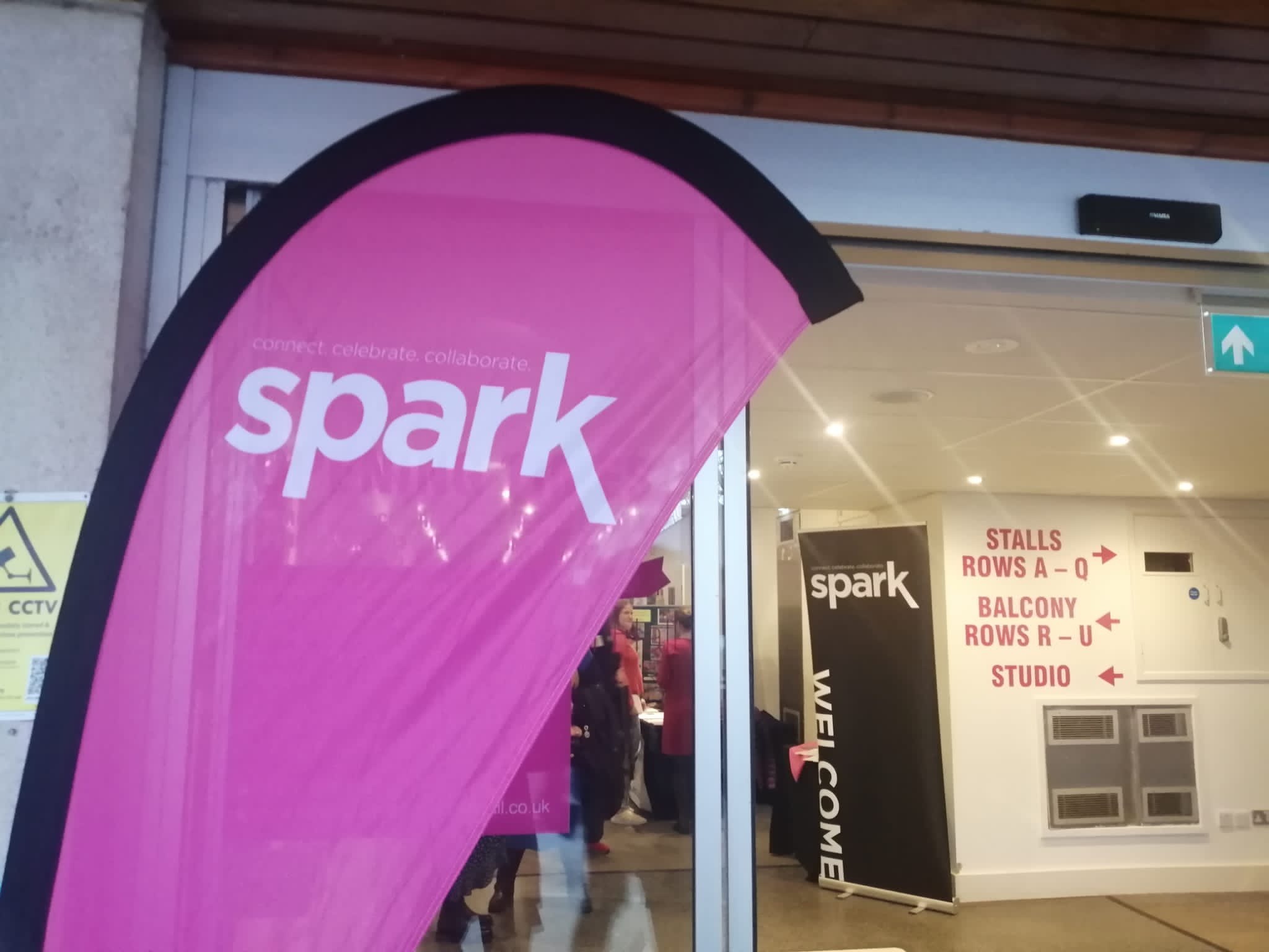 A pink flag banner reading 'Spark.'